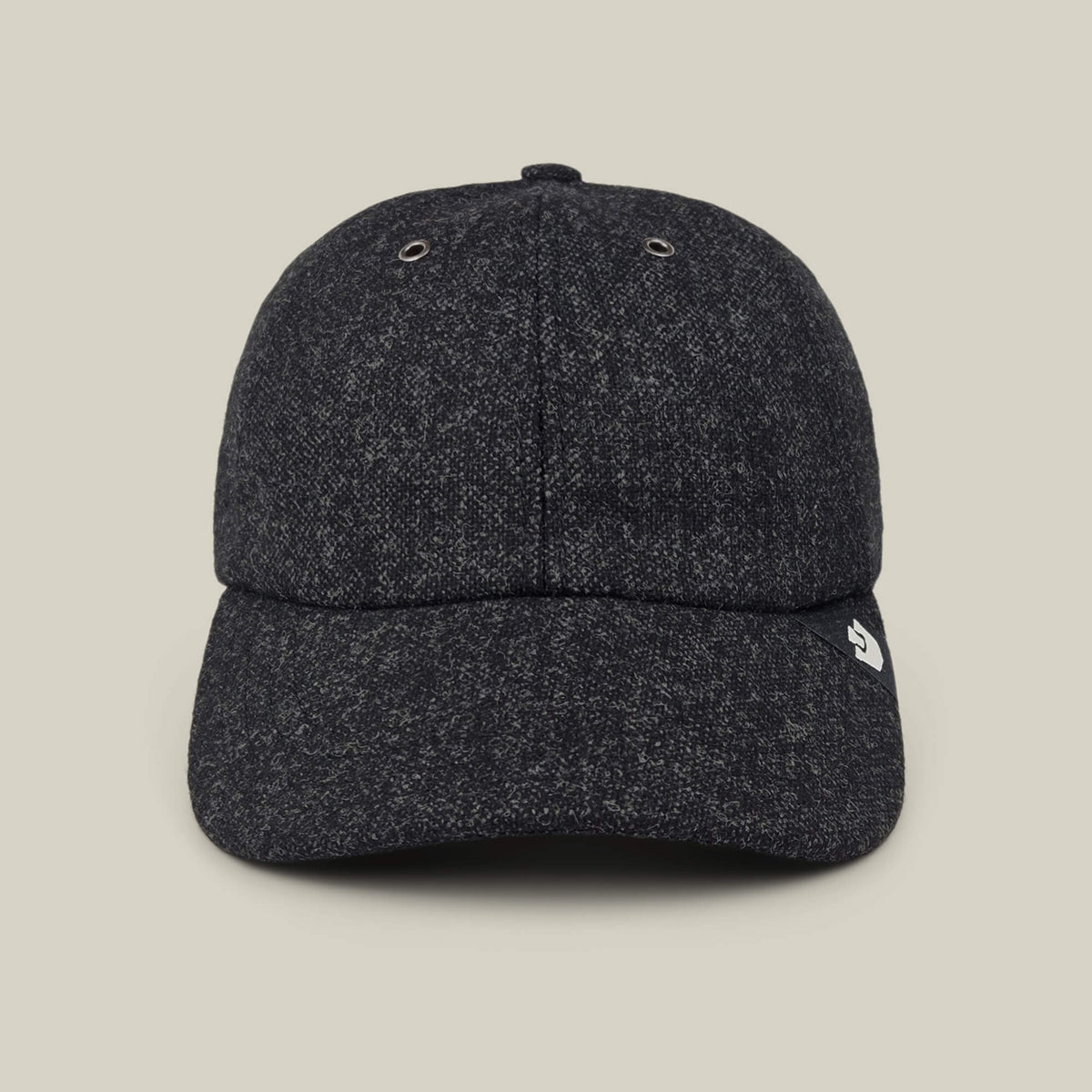 The Goorin Bros. Valmont is a dark gray textured wool baseball cap featuring a small white logo on the left side of the brim, made in the USA and photographed against a plain beige background.
