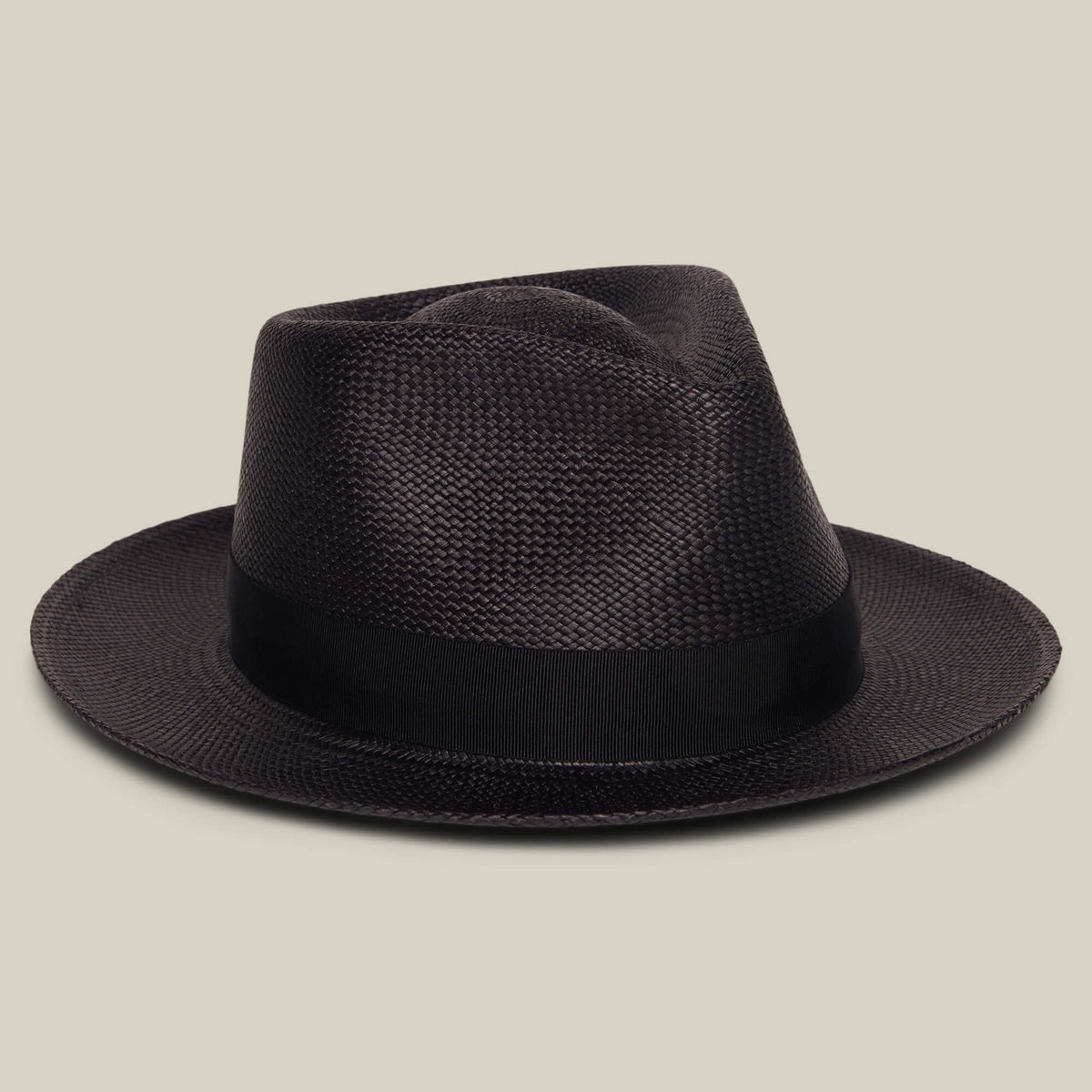 The Goorin Bros. John Sr. is a black toquilla teardrop fedora hat with a wide brim, black band, and 50 UPF sun protection, shown against a plain beige background.