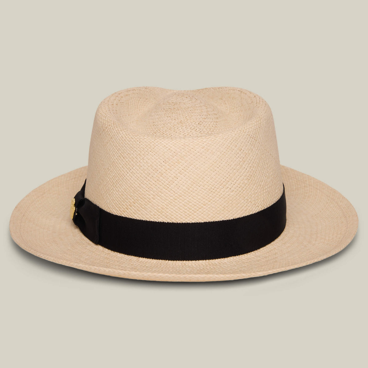 The Goorin Bros. John Sr. is a beige toquilla fedora hat with a wide brim and black ribbon band, offering 50 UPF sun protection, displayed on a neutral background.