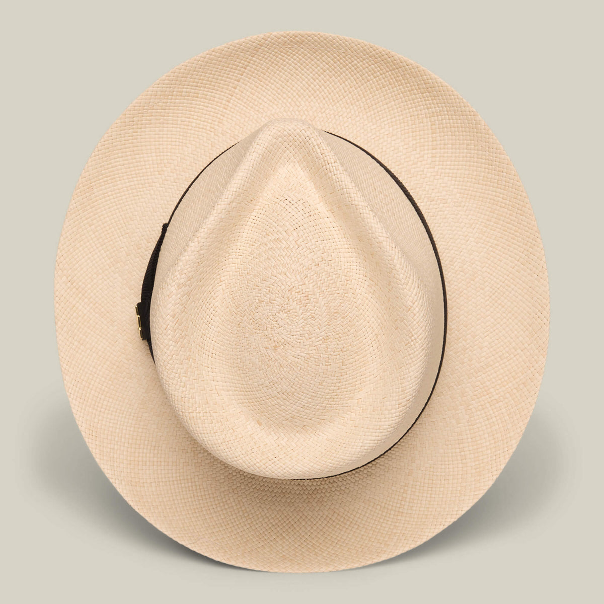 The Goorin Bros. John Sr. is a beige toquilla teardrop fedora with a wide brim, dark band, and 50 UPF sun protection, shown from above on a plain background.