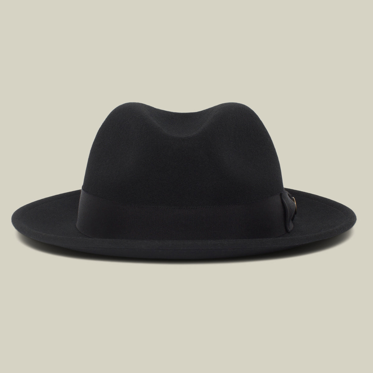 Dean the Butcher by Goorin Bros. is a black, American-made fedora featuring a wide brim and sleek grosgrain hatband, shown against a plain beige background.