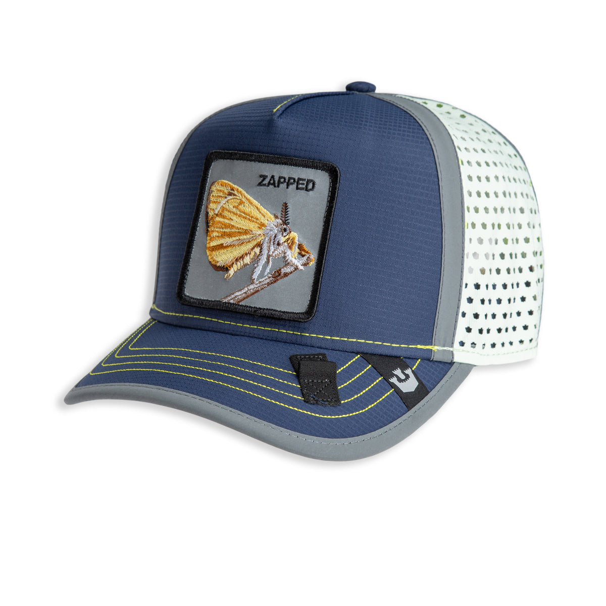 The Farm’s High Beams cap is a blue and white mesh trucker hat featuring a patch with a moth and the word “ZAPPED” on the front. Neon green stitching accents the brim and front panel, while water-resistant materials help keep you dry in unpredictable weather.