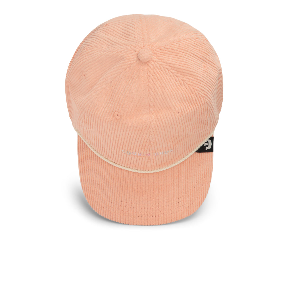 The Clubhouse by Goorin Bros. is a peach-colored Papa Cap made from wide wale corduroy, featuring a curved brim and a small logo tag on the side, epitomizing quiet luxury and showcased against a white background.