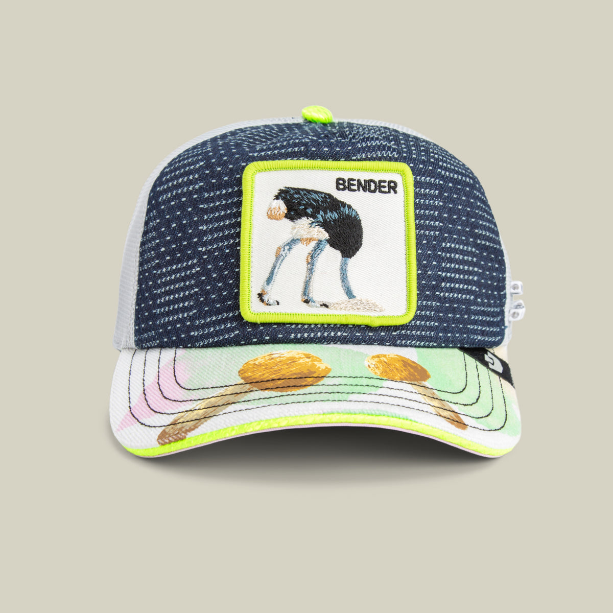 A blue and white Trance hat by Goorin Bros. features a front patch with an ostrich labeled BENDER and a brim decorated with eggs and spoons—making it the perfect festival accessory.