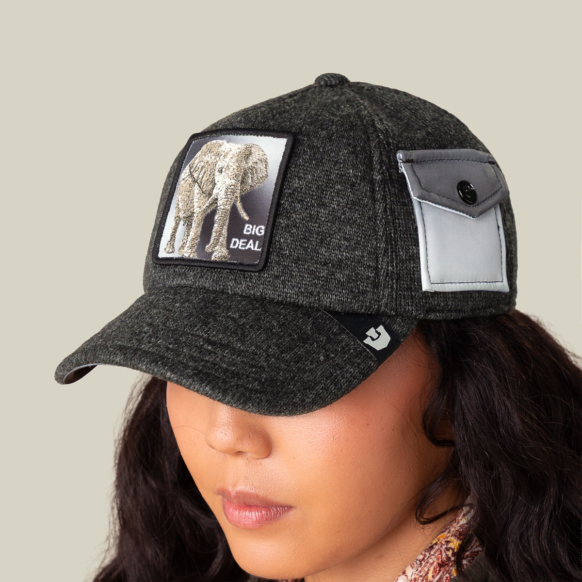 Wearing the Goorin Bros. "Kind of" cap: dark gray, elephant patch with "BIG DEAL" text, side pocket with button, all crafted from epic sweater material for ultimate comfort.