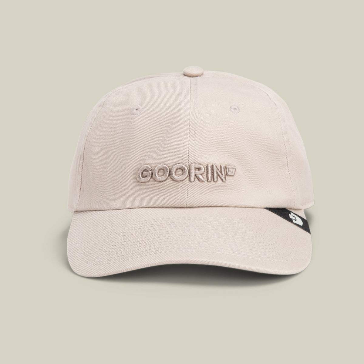 The Papa Core hat by Goorin Bros. features beige stitching, GOORIN embroidered on the front, and a small black tag on its curved brim, shown against a plain light background.