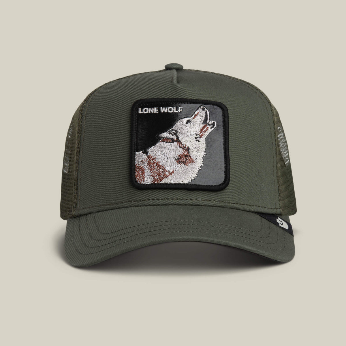 The Lone Wolf Trucker by Goorin Bros. in PALM channels outlaw style with mesh sides, a front patch of a howling wolf, and bold LONE WOLF text.