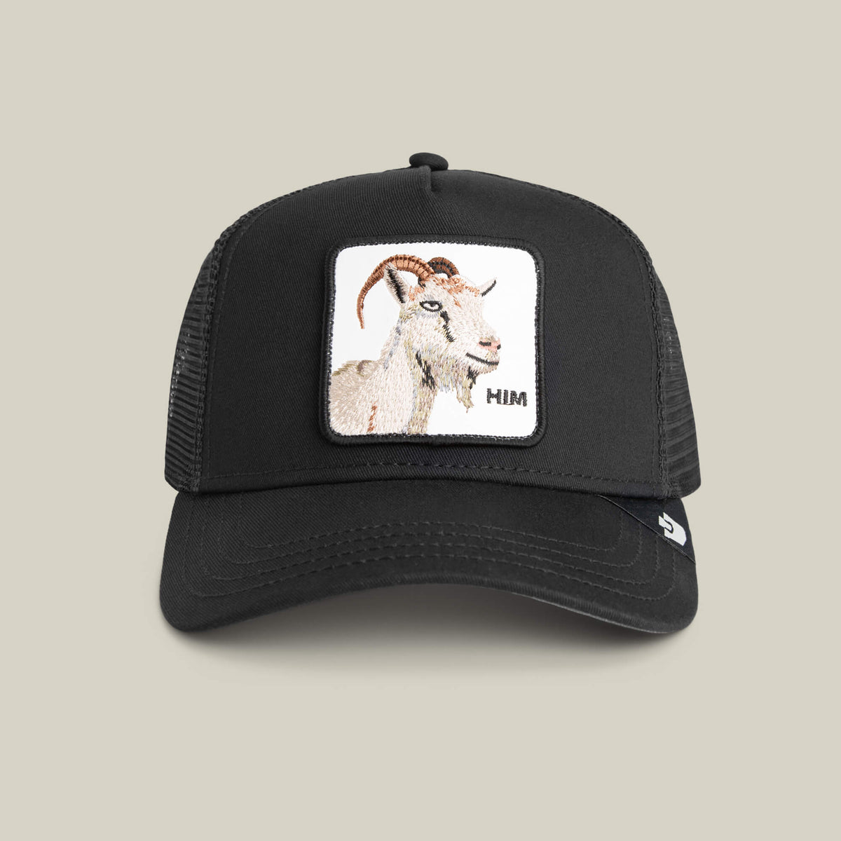 The Him Trucker by Goorin Bros. is a VOID-colored hat featuring a stitched front patch with an embroidered GOAT and "HIM" in the lower right corner.