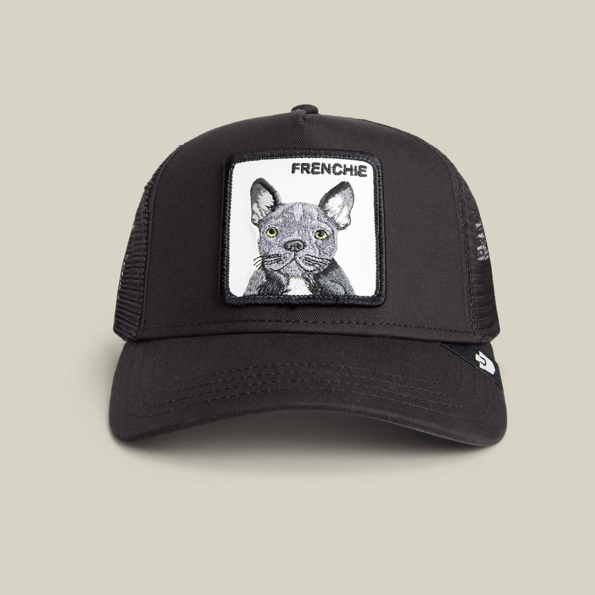 The Frenchie Trucker by Goorin Bros. is a bold black trucker cap in VOID color, featuring mesh sides and a front patch with an illustrated gray French Bulldog and the word "FRENCHIE" above it—an ideal hat for every Frenchie fan.