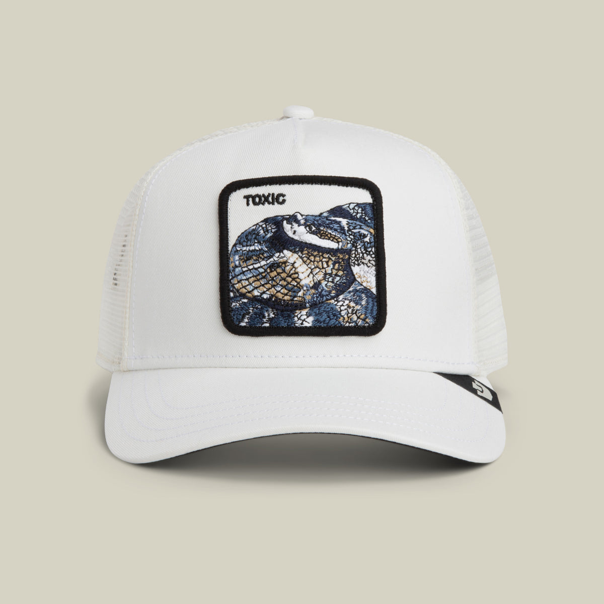 The Goorin Bros. Toxic Trucker is a dust-colored mesh hat featuring a patch with an embroidered snake and the word "TOXIC" above it.