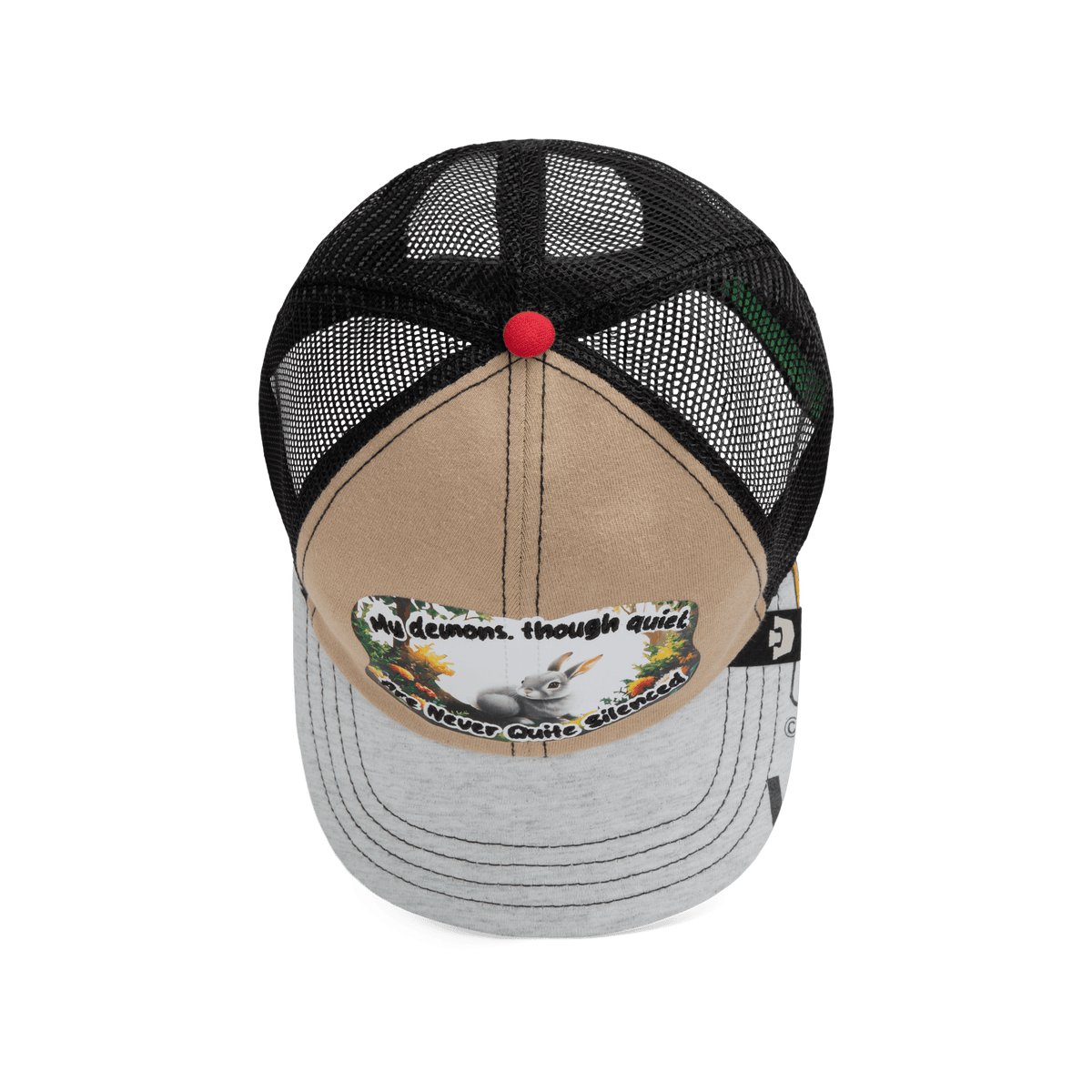 The Lil Ronin trucker hat from Goorin Bros.' Storybook collection features a tan and gray front, black mesh back, and a patch with text plus a graphic of a dog with flowers.