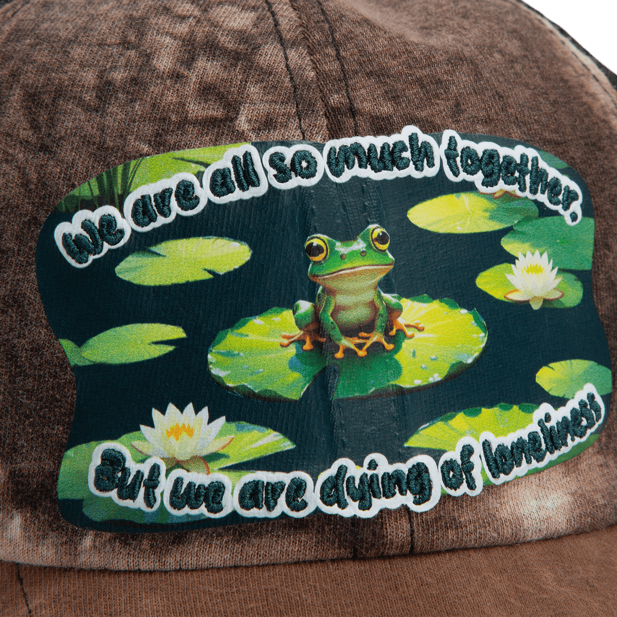 The Goorin Bros. Lil Sohei cap from our Storybook collection features a frog-on-lily pad patch and the phrase, "We are all so much together, but we are dying of loneliness." Discover hats that tell a story.