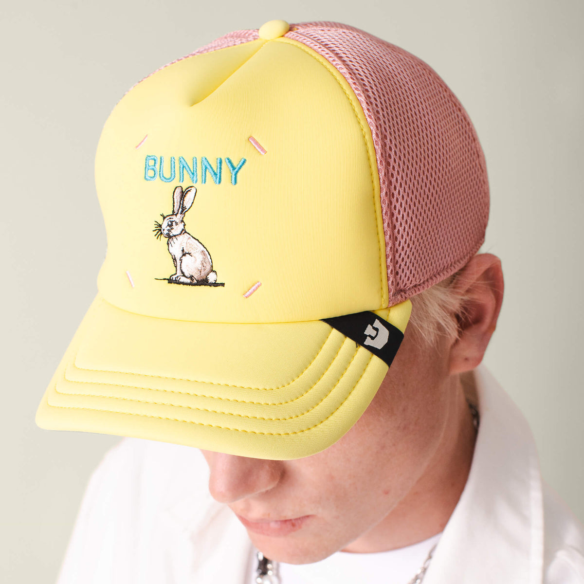 Person wearing the Goorin Bros. Neo Farm - Bunny Rabbit hat in yellow and pink mesh, with an embroidered rabbit and "BUNNY" on the frontβperfect for everyday wear.