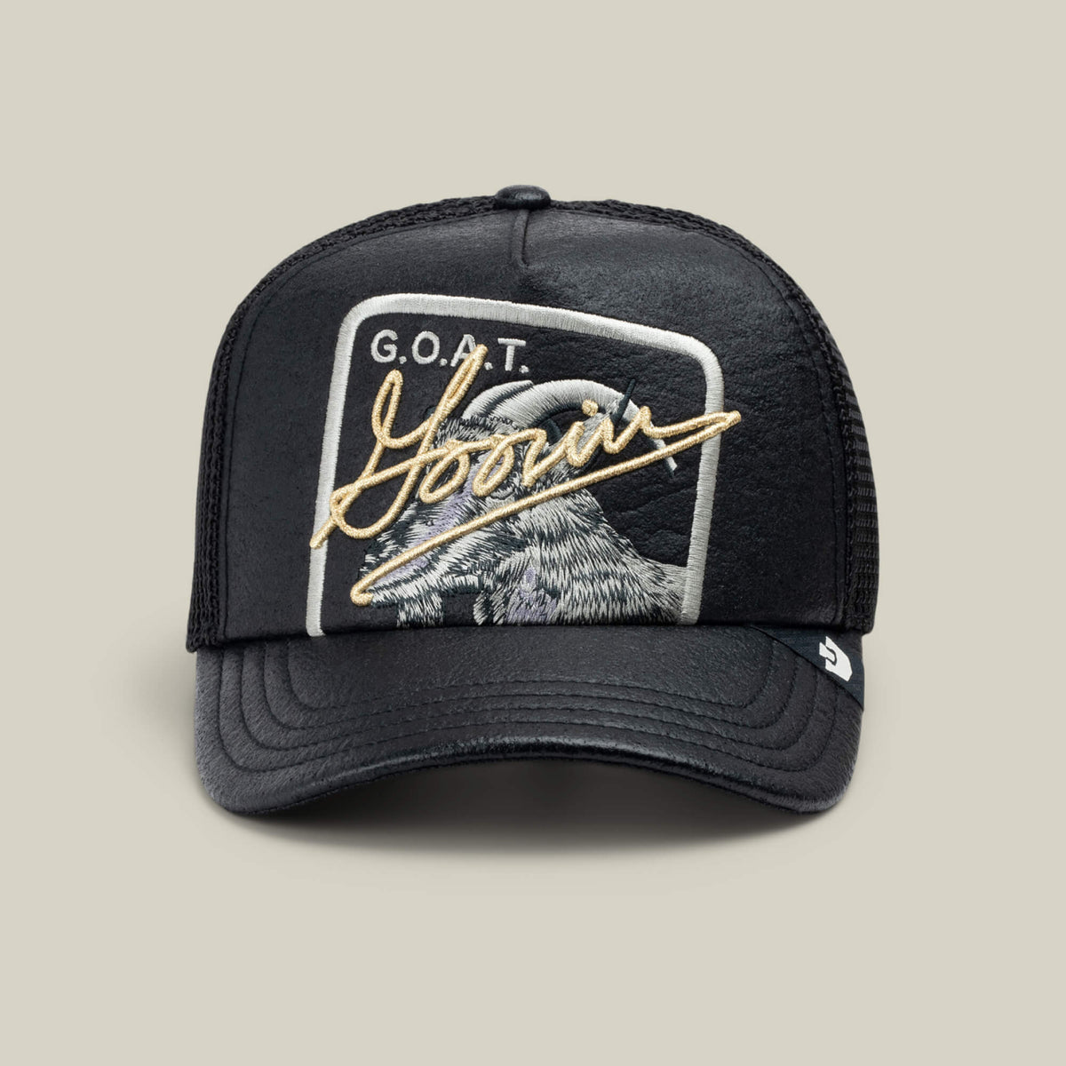 The Goorin Bros. NeoBrand GOAT is a black mesh trucker cap with a goat patch, "G.O.A.T." text, and "Yours" in gold script—perfect to pair with your all-black sneakers.