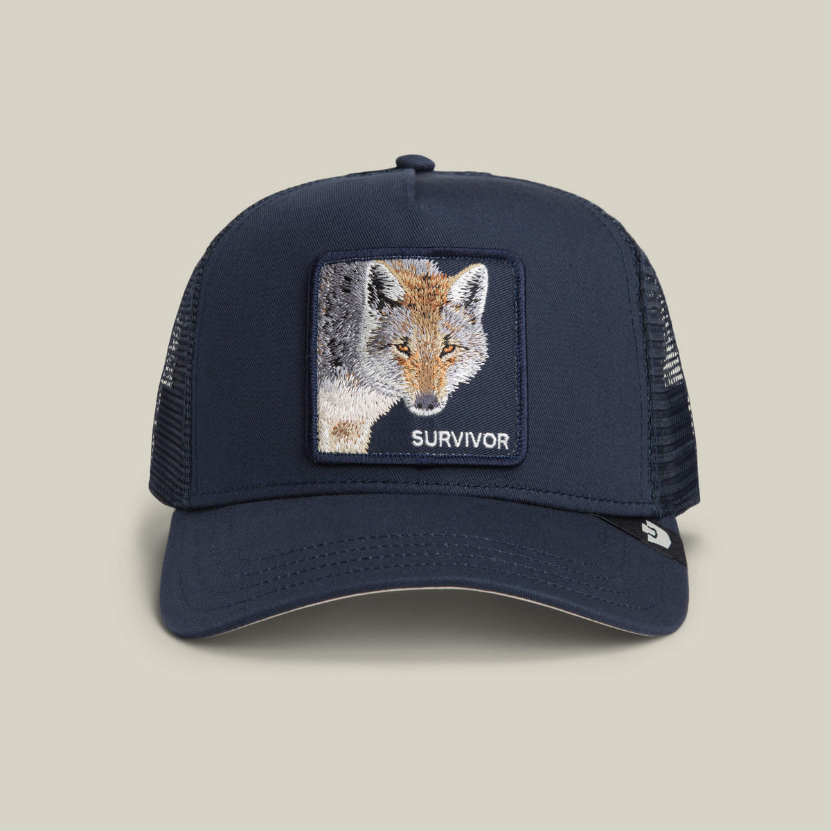 Goorin Bros. Mirage Survivor hat in EDGE color, featuring a mesh trucker design and an embroidered fox patch with the word SURVIVOR on the front panel, is displayed on a neutral background.