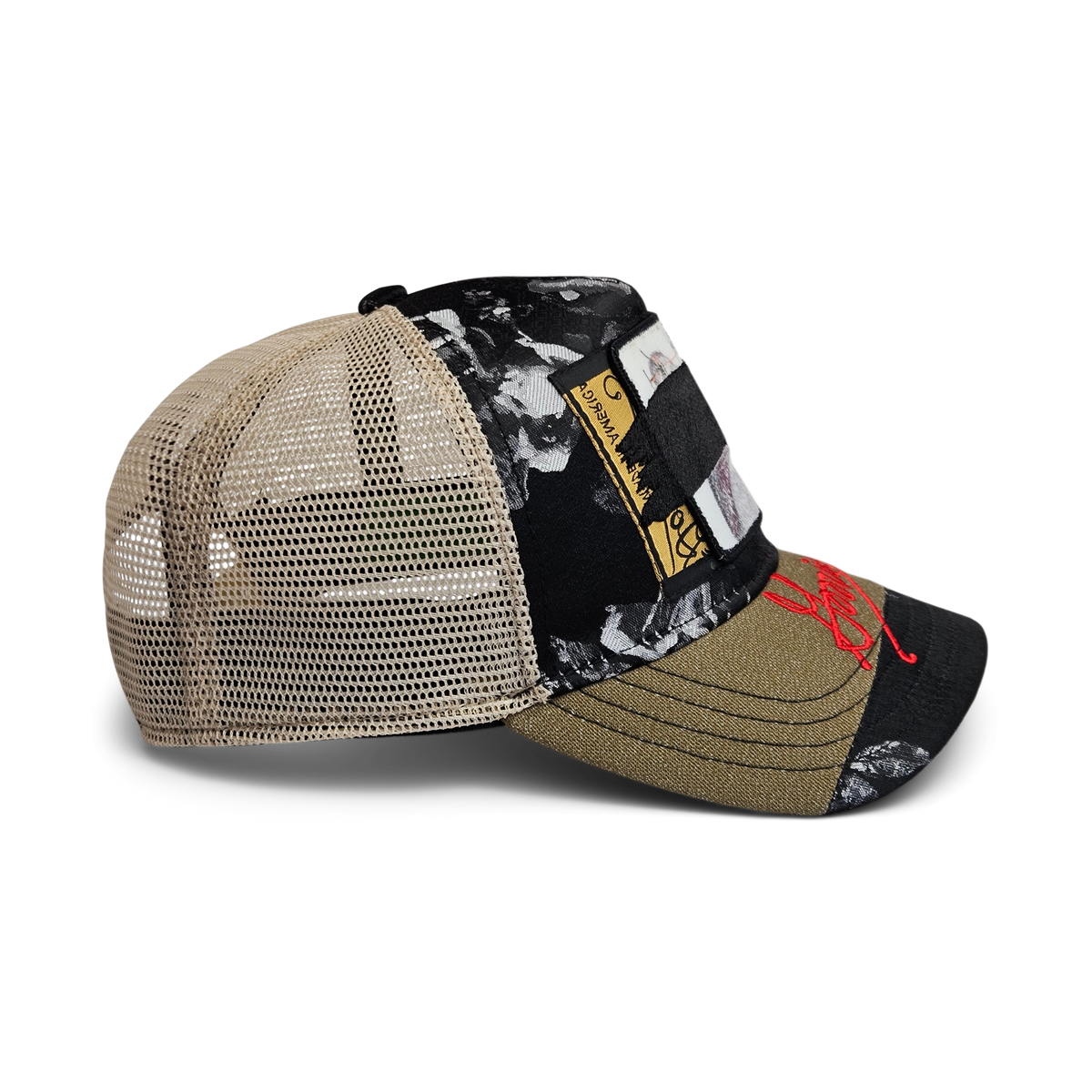 Side view of the Goorin Rework Trucker by Goorin Bros., a limited edition trucker hat with a mesh back, black and olive green floral-patterned fabric, decorative patches, and red embroidery on the brim.