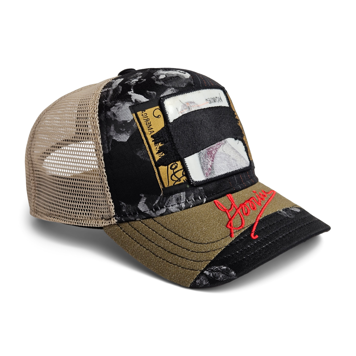 The Goorin Bros. Goorin Rework Trucker is a limited edition hat with a tan mesh back, black and olive panels, patchwork designs, floral patterns, and red embroidered text on the brim.