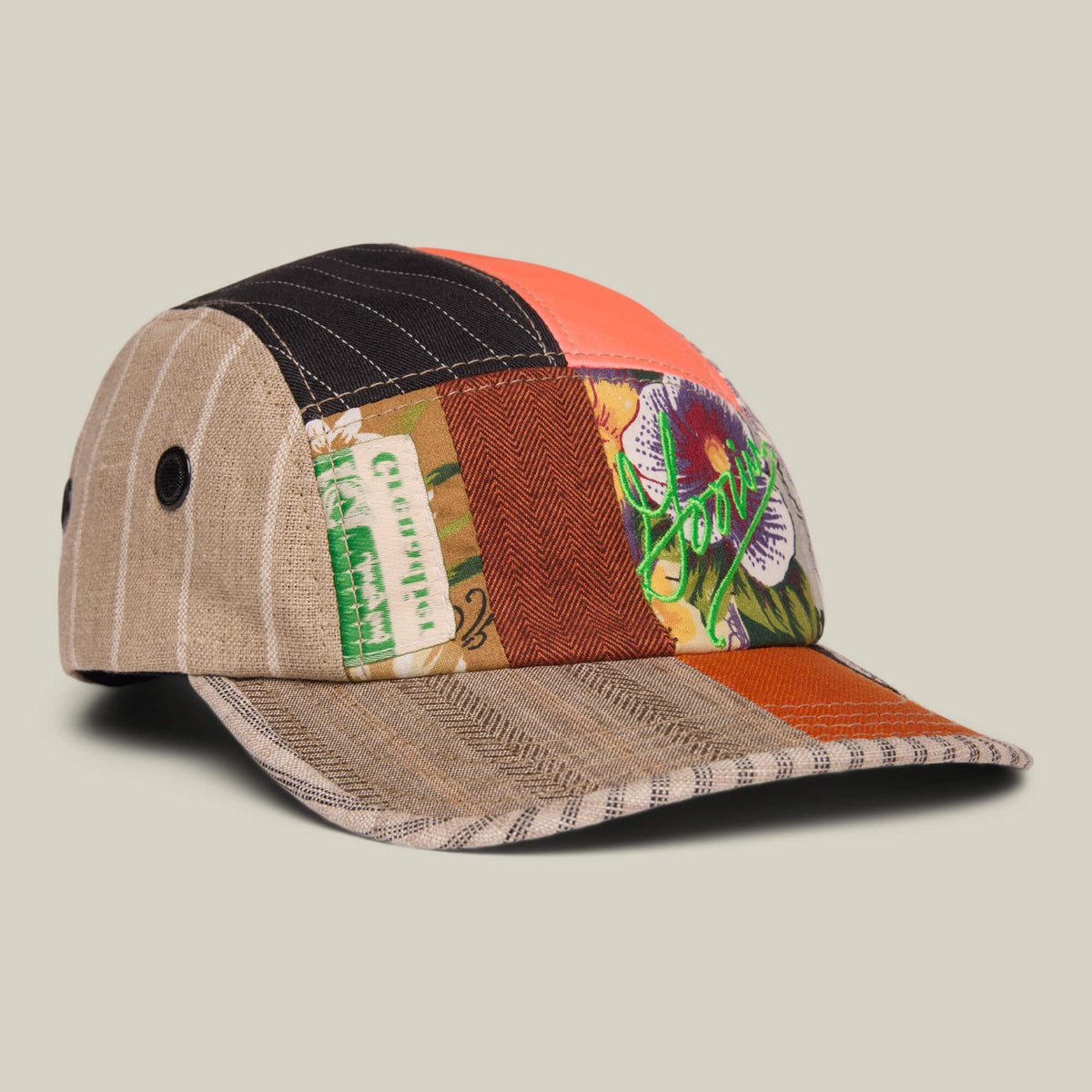 The Goorin Rework Camper by Goorin Bros. is a limited edition, multicolored patchwork baseball cap with stripes, text, and floral fabric patterns, displayed against a neutral background.
