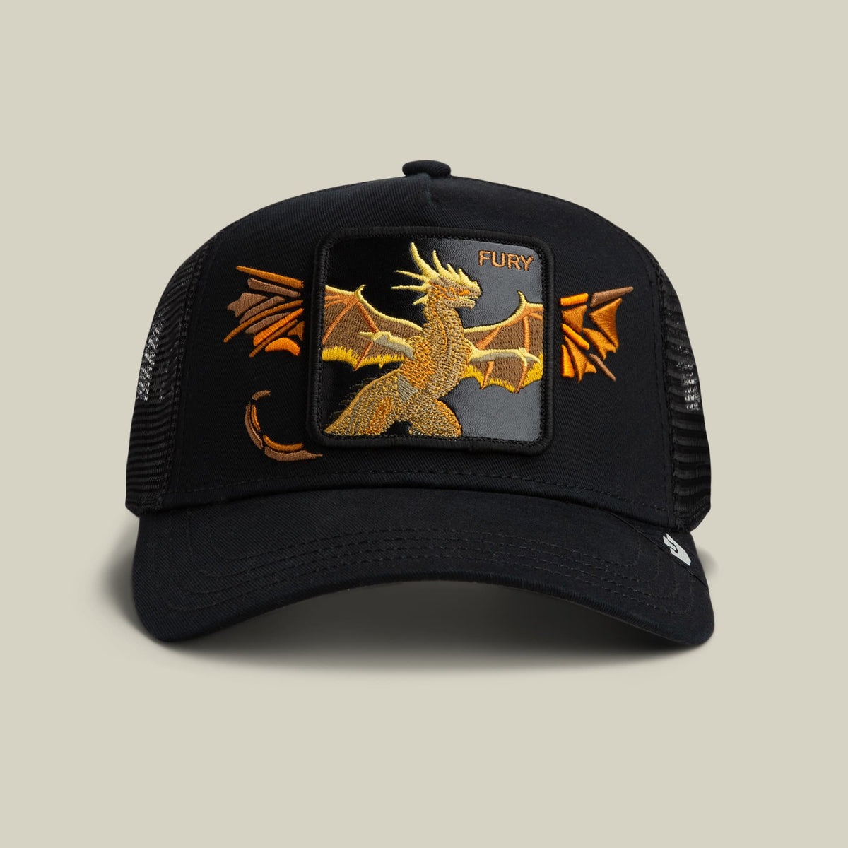 Wings Fury by Goorin Bros is a black mesh trucker hat featuring a gold embroidered dragon patch with orange accents on the front and wings on the sides, displayed against a neutral background.