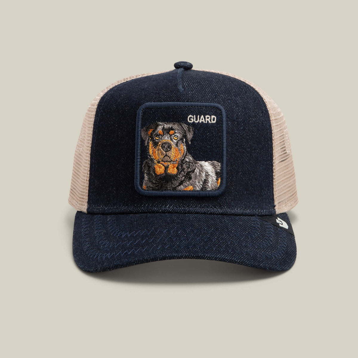 Introducing the Goorin Bros. Denim Guard—a dark denim snapback trucker hat featuring a square embroidered Rottweiler patch with the word "GUARD" on a light tan mesh background.