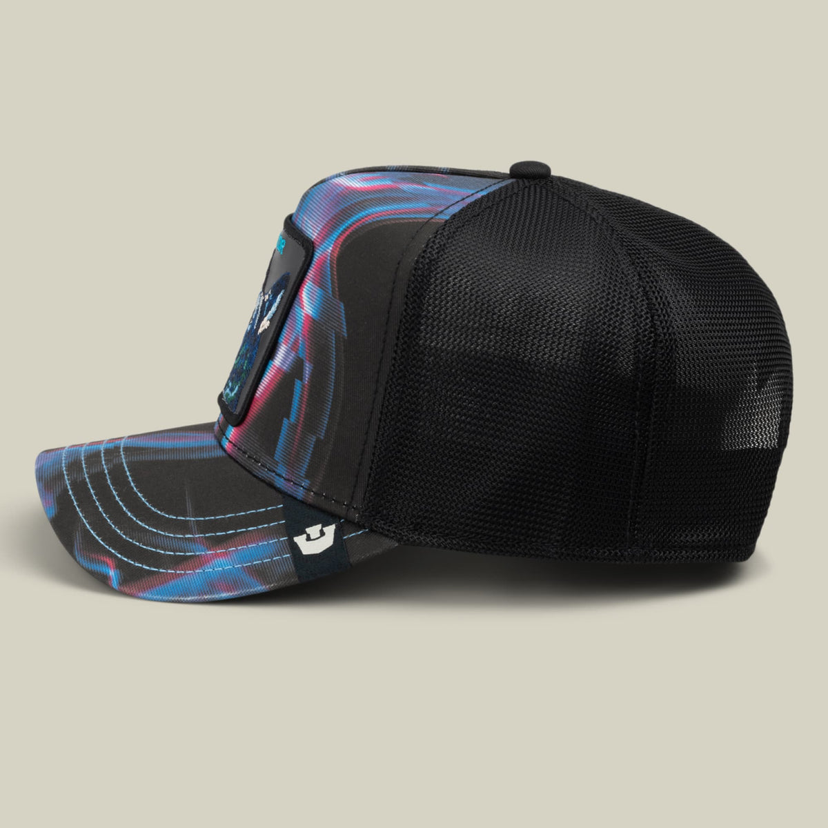The Goorin Bros. Baba Yaga trucker hat features a black mesh back with a colorful striped front panel in blue and pink, displayed against a neutral background.