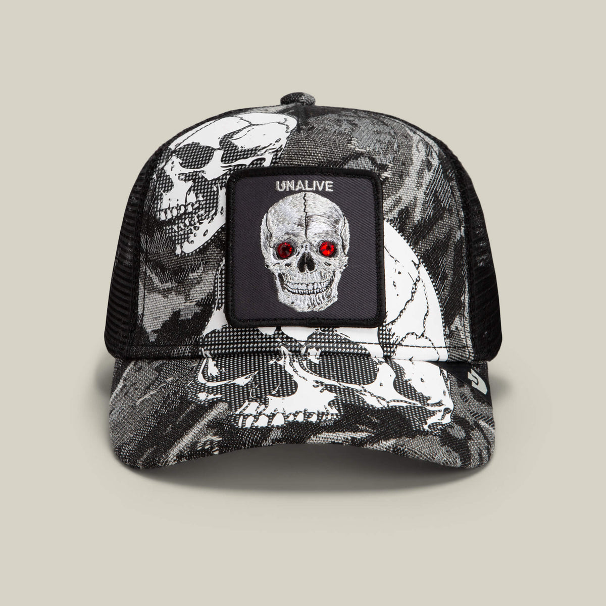 The Goorin Bros. Bone Head Unalive trucker hat in Void features a striking black and white skull print with vivid red eyes, a bold “UNALIVE” patch above the graphic, and a skull pattern across the front and brim. Finished with a breathable mesh back for all-day comfort, this classic design expertly combines edgy style with signature Goorin Bros. craftsmanship.