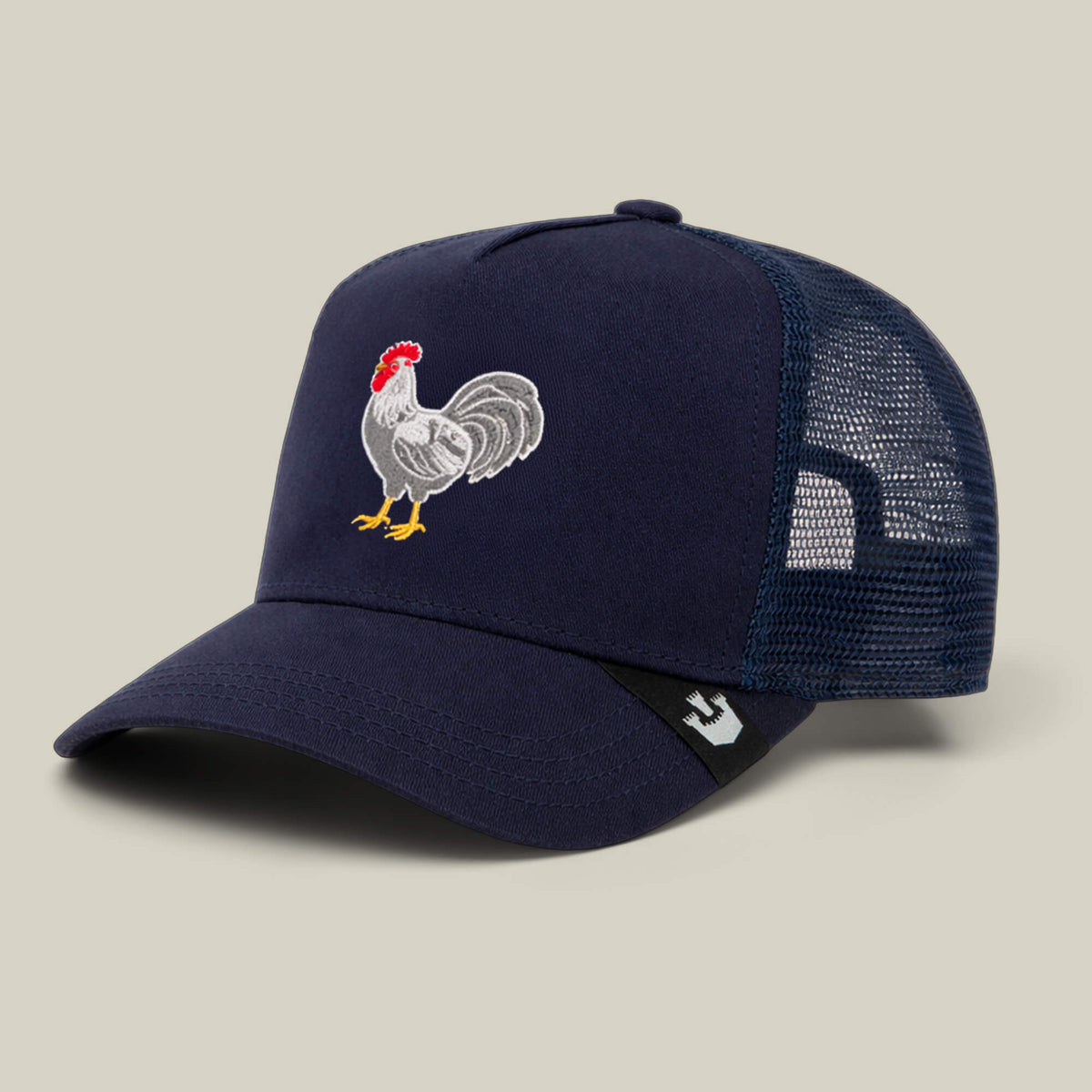The Goorin Bros. Gone Cockmaxxing trucker hat features a navy blue design, mesh back, and a full front panel embroidered with a rooster.