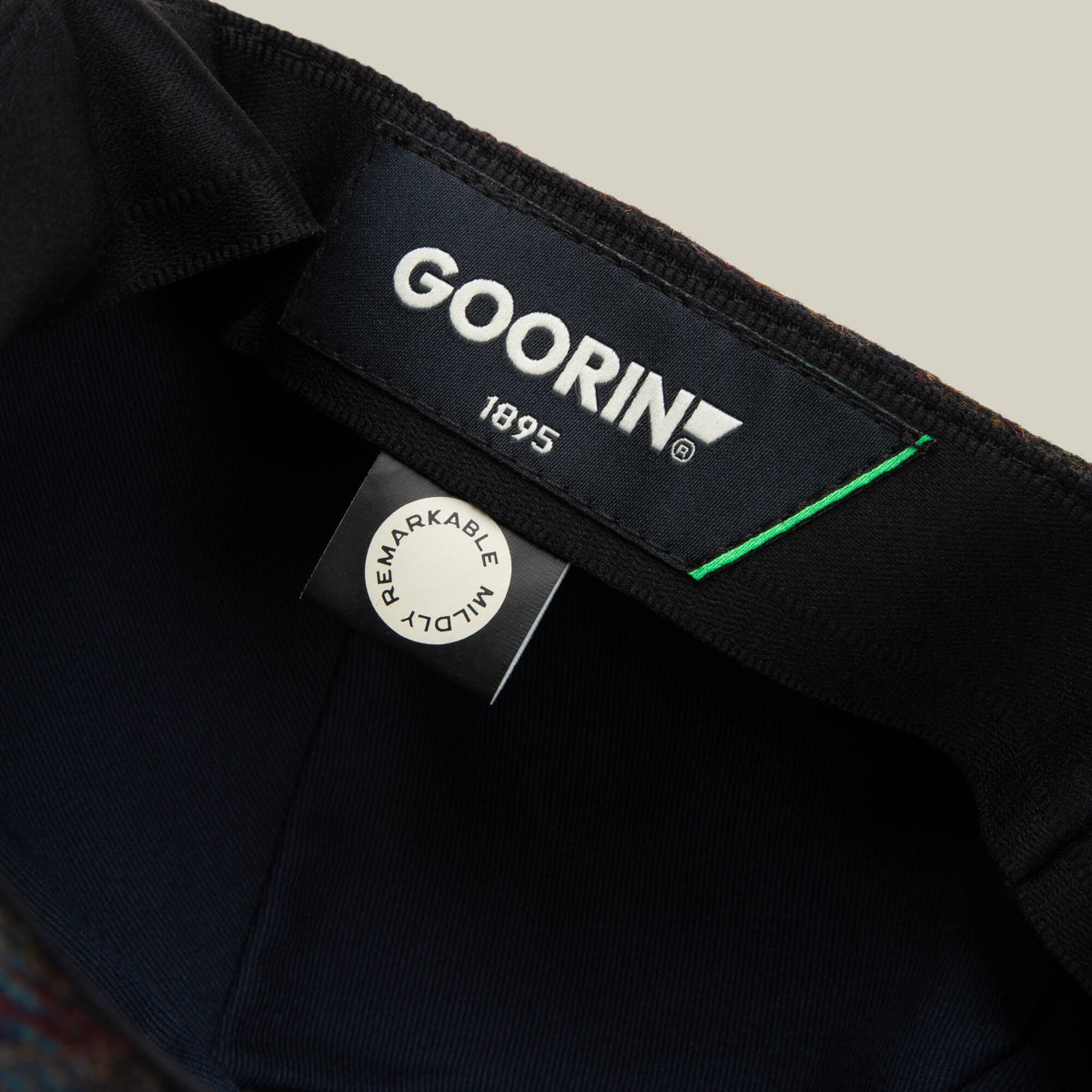 Close-up of the inside label on the Cozy Benjamin Paul hat by Goorin Bros., showing the brand name, year 1895, and a tag that reads “REMARKABLY WELL MADE.”.