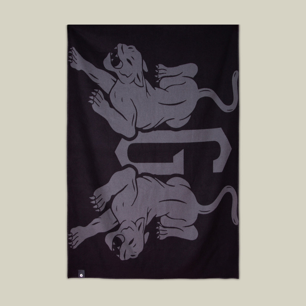 The Goorin Bros. Panther Crest Blanket in VOID features two mirrored gray panthers and a stylized “G” at the center—a bold statement piece for your space.