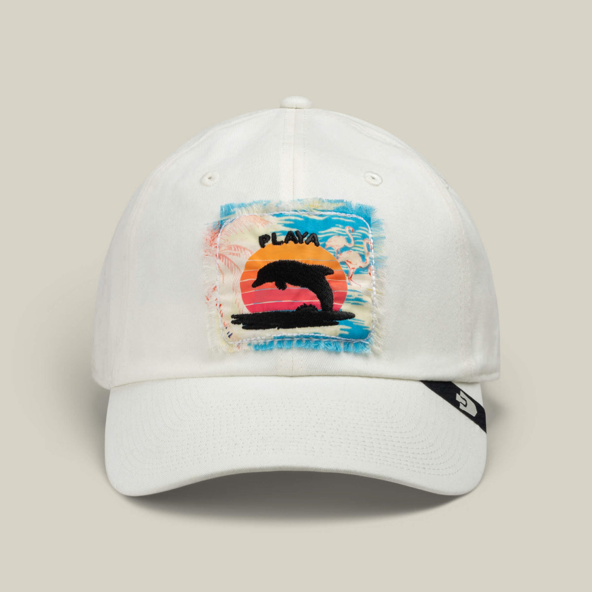 White distressed patch cap by Goorin Bros., named “OOO.” Features a patch showing a jumping dolphin with a sunset, ocean, and palm tree background and the word PLAYA above the dolphin. Offers the classic Papa Cap Fit and includes a black logo tag on the brim’s side—perfect for Personal Beach Maintenance days.