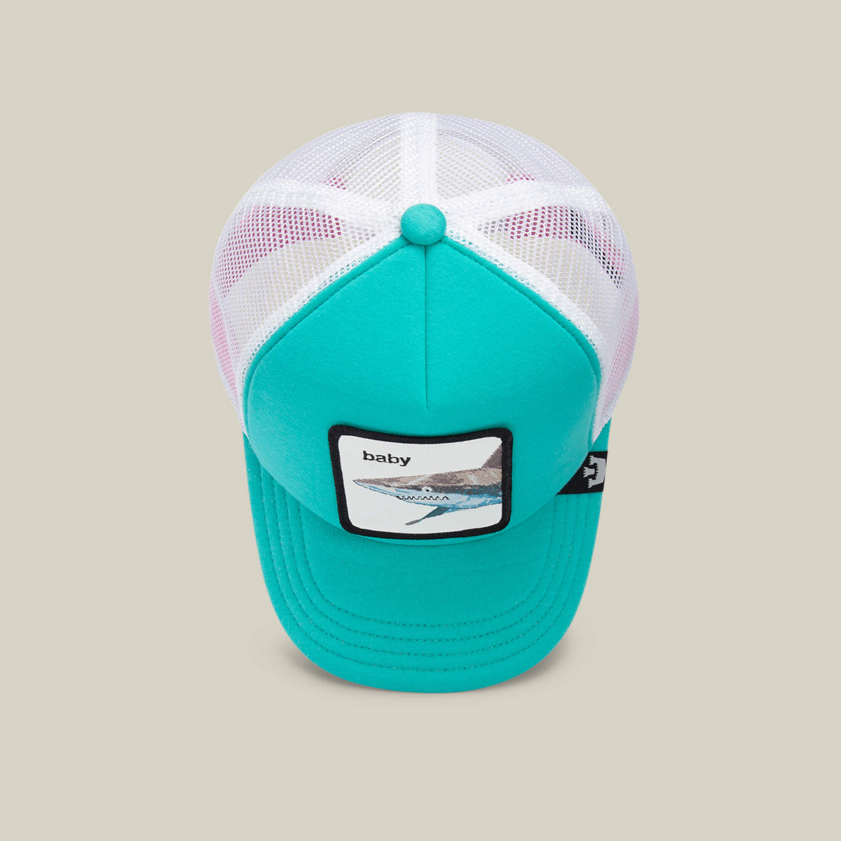 A turquoise and white mesh trucker hat by Goorin Bros., named “Do Do Doodoo Doodoo,” makes a perfect aqua kids cap and features a front patch with the word “baby” alongside an abstract design.