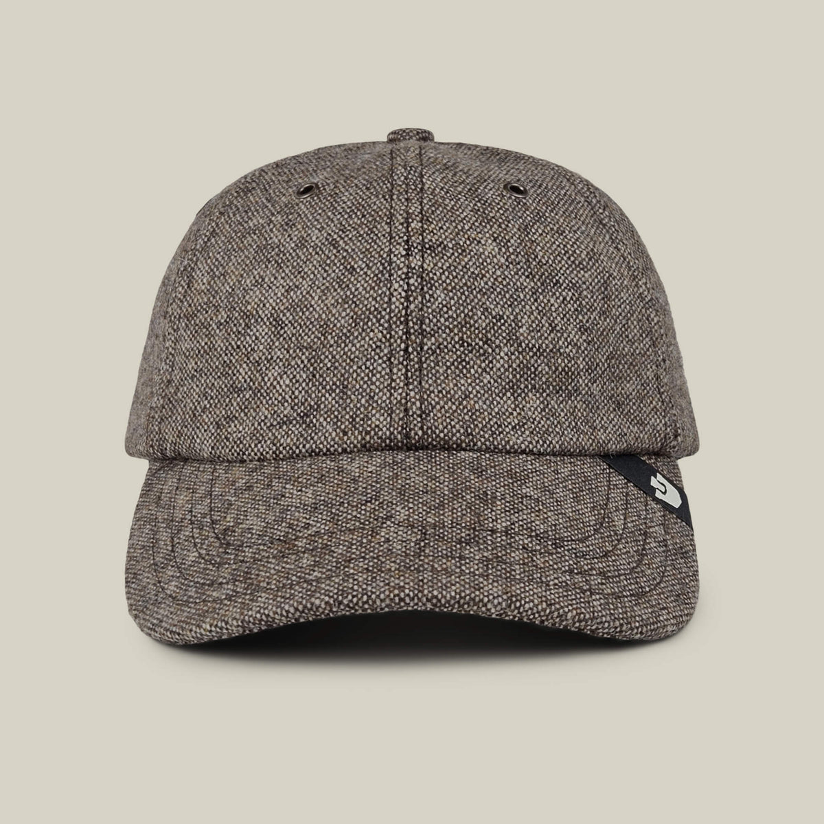 The Goorin Bros. Valmont is a brown textured wool baseball cap with a curved brim and a black tag on the right side, made in the USA and shown against a plain beige background.