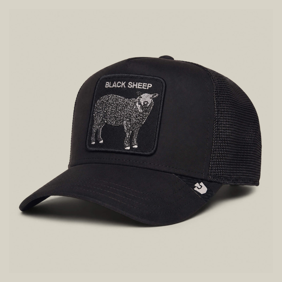 The Suede Sheep cap by Goorin Bros. is a black and white mesh trucker hat featuring a stylish suede feel and a front patch with a black sheep and the text “BLACK SHEEP” set against a neutral backdrop.