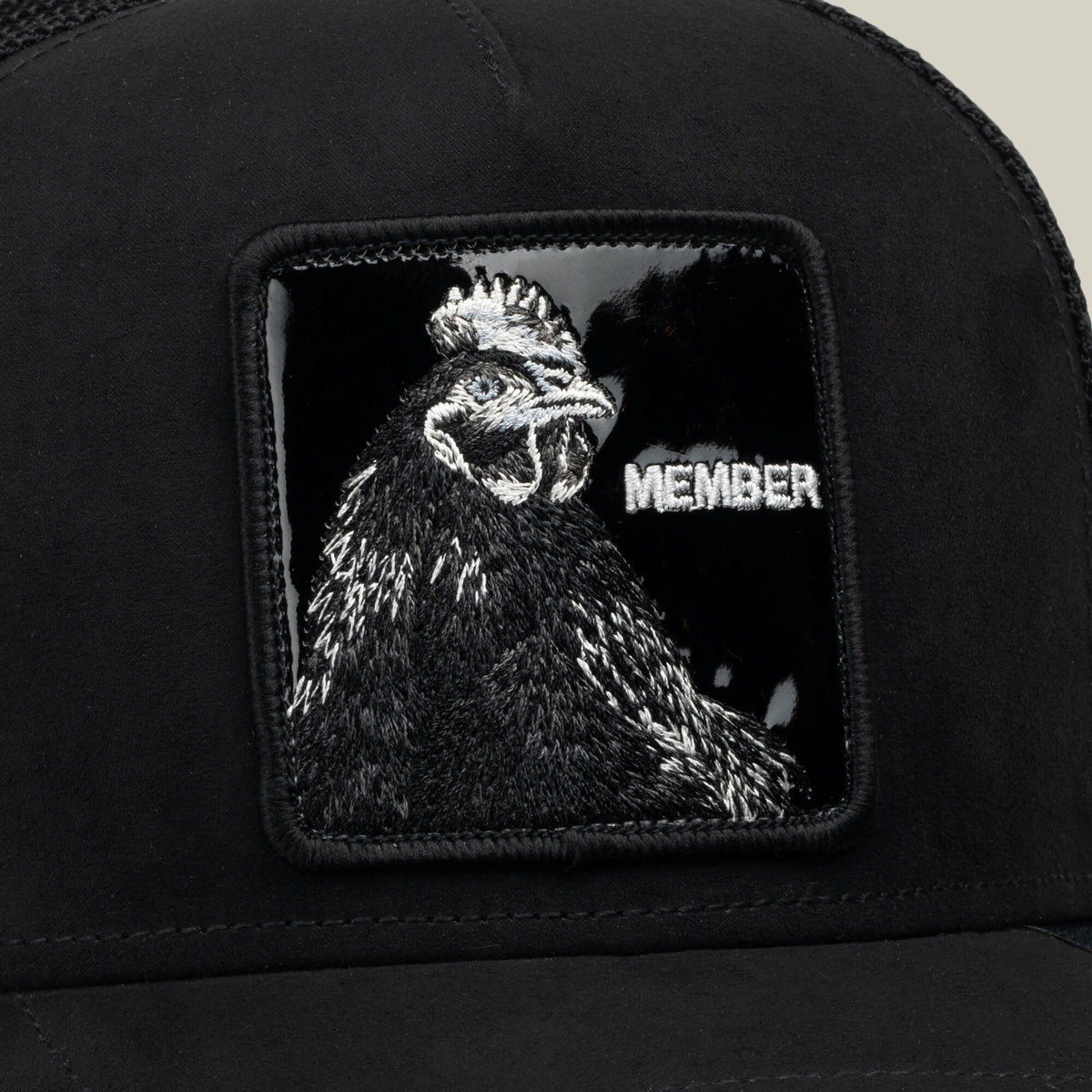 Introducing the Goorin Bros. Black Out Rooster hat, crafted from jet-black polyester and featuring a MEMBER patch adorned with a sewn black rooster and the word “MEMBER” in white on a glossy black background.