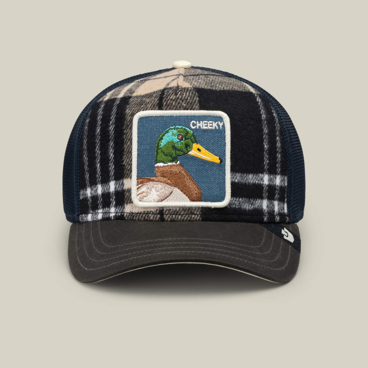 The Goorin Bros. Brit Cheeky is a plaid mesh cap with a curved brim and breathable mesh back, featuring a front patch embroidered with a mallard and the word “CHEEKY.”.