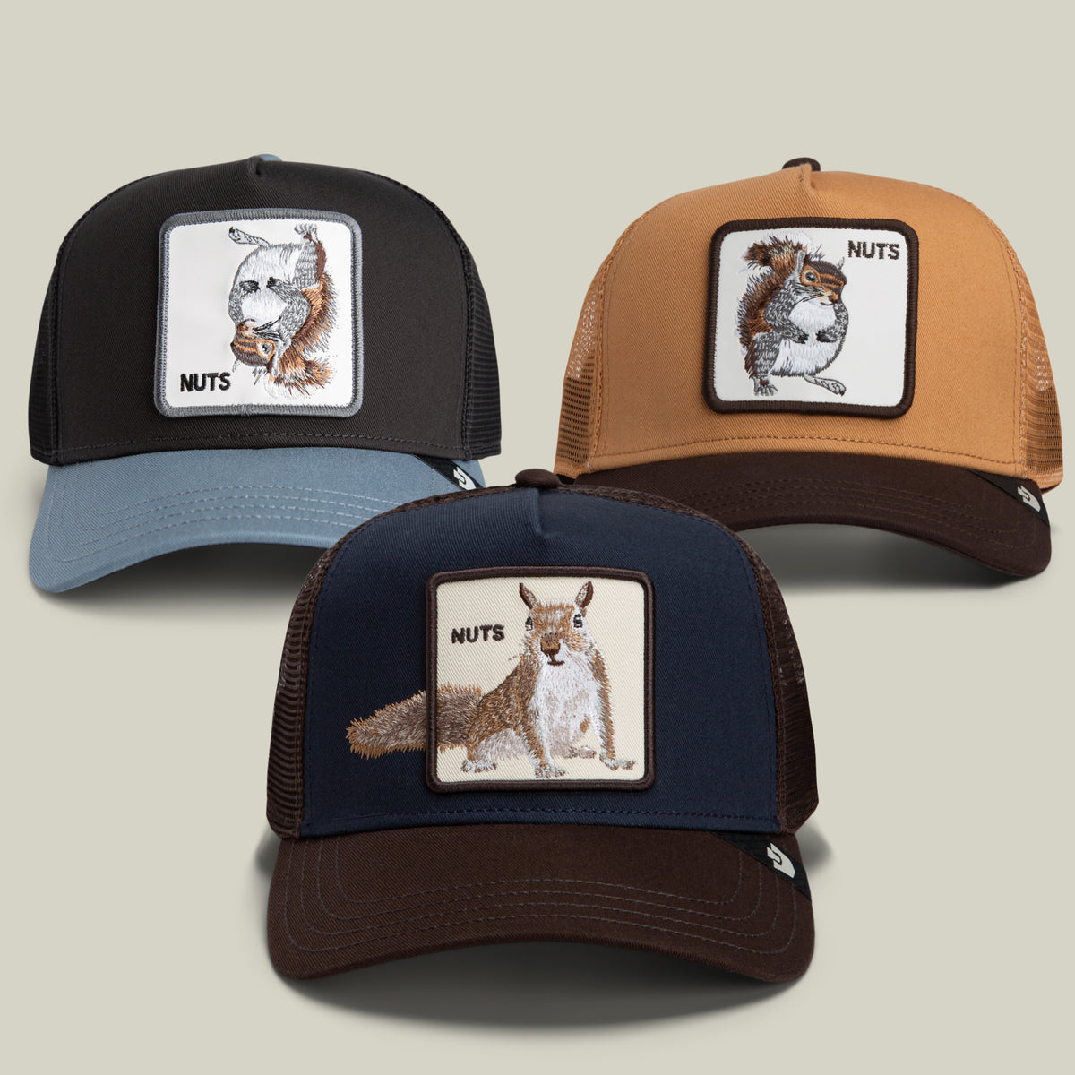 Introducing the Nut Luvr Bundle by Goorin Bros.—a set of three trucker hats featuring embroidered squirrel patches and the word “NUTS,” perfect for bold personalities with a fondness for small animals. The bundle includes black, brown, and navy hats with mesh backs, all shown against a simple light background.