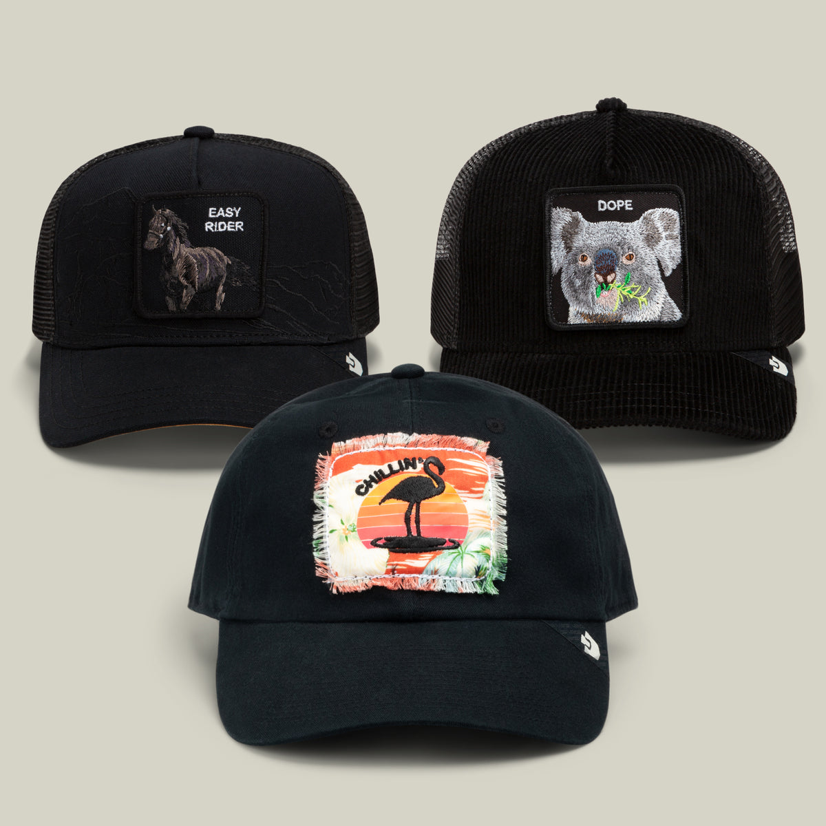 The Relax, Buddy Bundle by Goorin Bros. features three all-black baseball caps with animal patches: a horse labeled Easy Rider, a koala labeled Dope, and a flamingo against an orange sunset background labeled Chillin—perfect for those who like to relax in style.