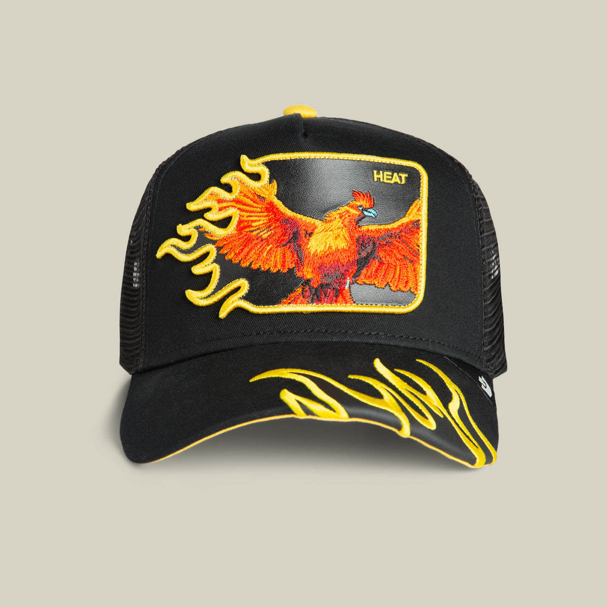 Unleash bold style with the Goorin Bros. Heat Flames trucker hat, featuring black mesh and a fierce phoenix surrounded by yellow flame embroidery on the front and brim, along with “HEAT” stitched into the design. This standout Heat Flames cap adds dynamic energy to any outfit with its eye-catching flame details—perfect for those who embrace blazing looks.