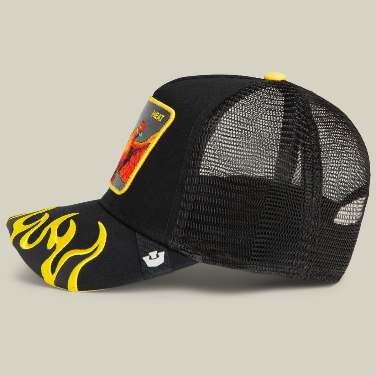 Introducing the Heat Flames trucker cap by Goorin Bros.—a black mesh snapback featuring a striking yellow flame design on the brim and a vibrant front patch with a person illustration. This bold statement piece is perfect for anyone looking to add fiery style to their look.
