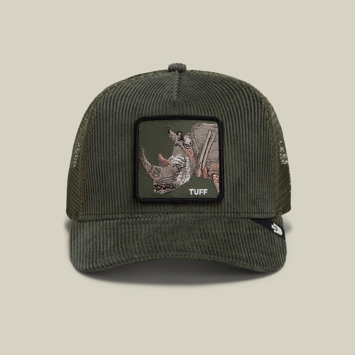 The Goorin Bros. Corduroy Tuff is a dark green trucker hat made from a durable polyester-cotton blend, featuring corduroy fabric on the front, a mesh back, and an embroidered rhinoceros patch with the word “TUFF” on the front.