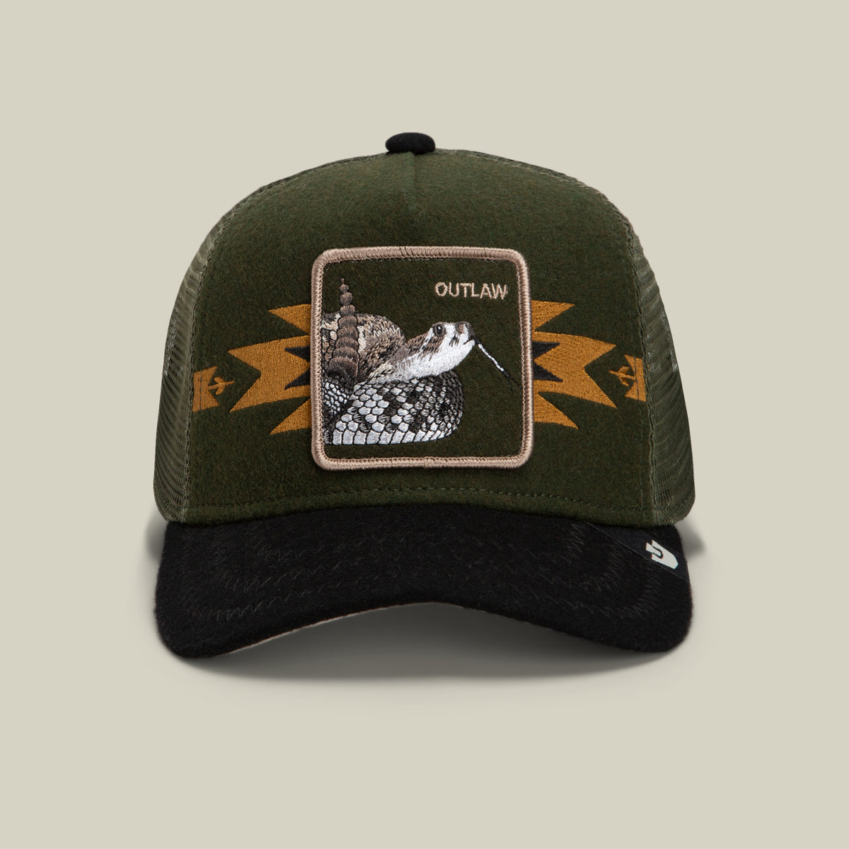 Channel your outlaw energy with the Canyon Outlaw trucker hat by Goorin Bros.—a green and black wool blend cap with a breathable mesh back, bold geometric gold detailing, and a striking rattlesnake patch labeled OUTLAW on the front.