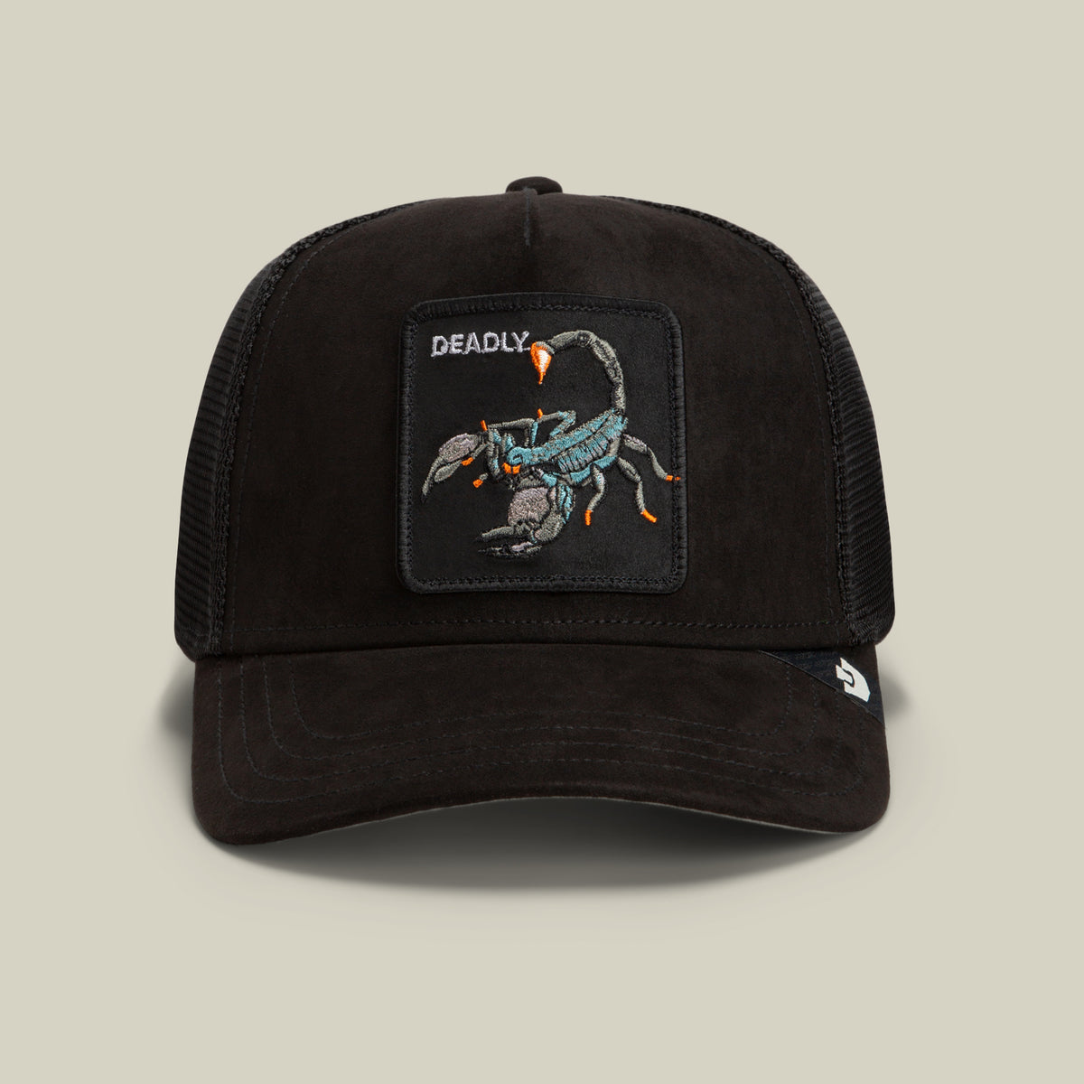 The Goorin Bros. Suede Scorpion is a black trucker hat featuring a suede front with a patch of a scorpion and the word “DEADLY” embroidered above it, complemented by a breathable mesh back and curved brim.