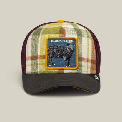 Introducing the Brit Sheep trucker hat from Goorin Bros.—a fall-ready plaid cap featuring a black bill, mesh back, and a distinctive BLACK SHEEP patch on the front. Crafted with a wool blend, this playful accessory brings rebellious charm to your autumn wardrobe.