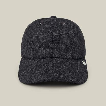 The Goorin Bros. Valmont is a dark gray textured wool baseball cap featuring a small white logo on the left side of the brim, made in the USA and photographed against a plain beige background.