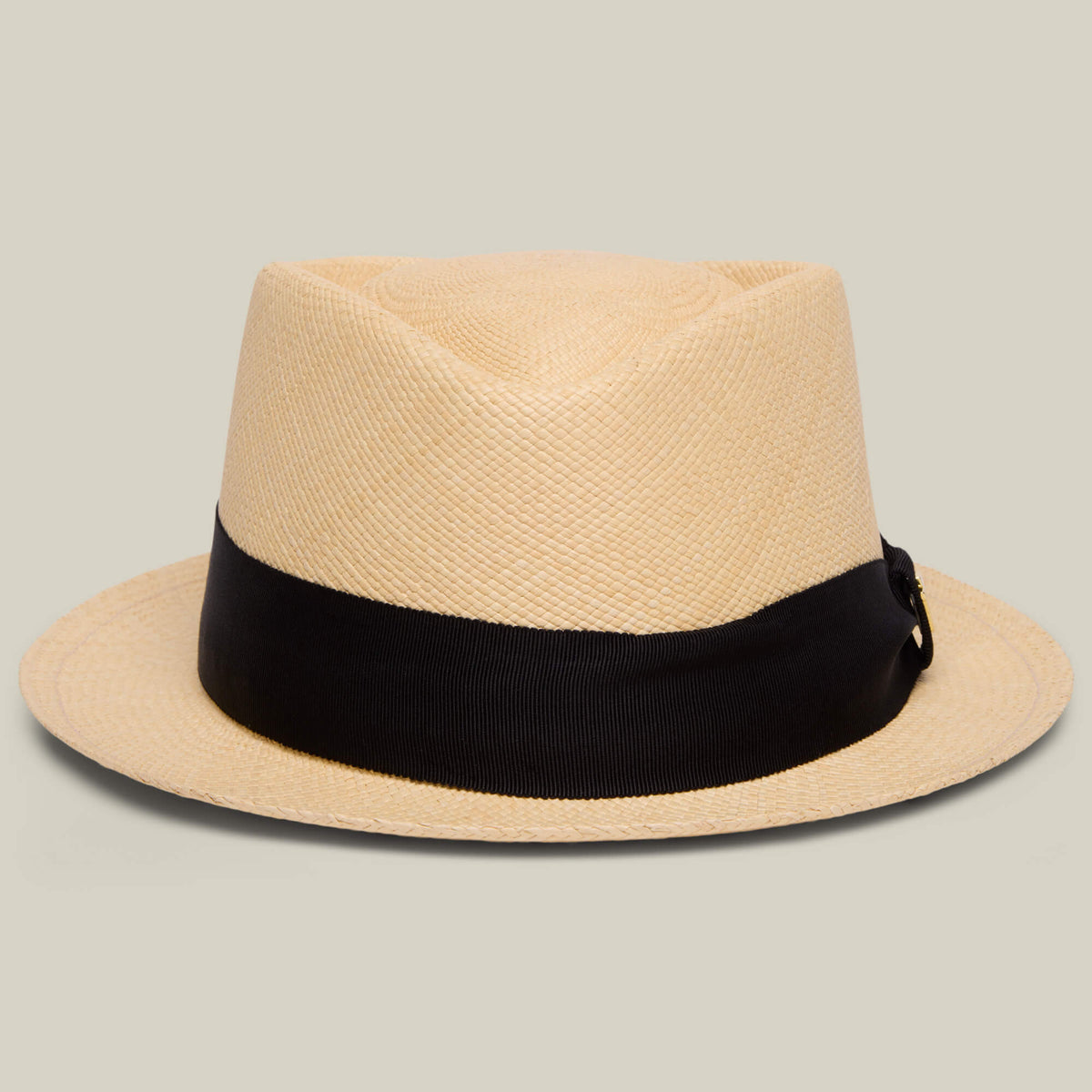 The That's All Folks Panama hat by Goorin Bros., in TOAST, is handwoven in Ecuador with a beige crown and wide black band, shown on a plain light background.