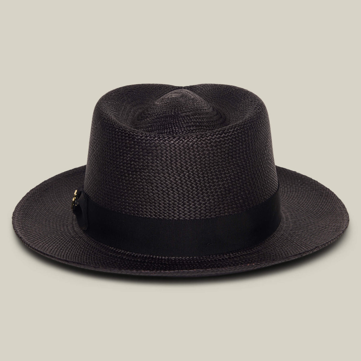 The Goorin Bros. "John Sr." is a dark brown toquilla teardrop fedora hat with a black ribbon band and 50 UPF sun protection, shown against a plain beige background.