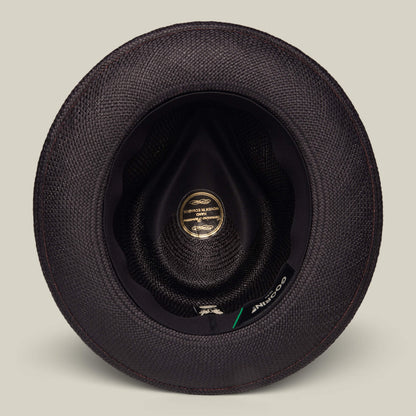 Top-down view of the inside of a black textured John Sr. teardrop fedora by Goorin Bros., featuring a gold label, black inner lining, and designed for 50 UPF sun protection.