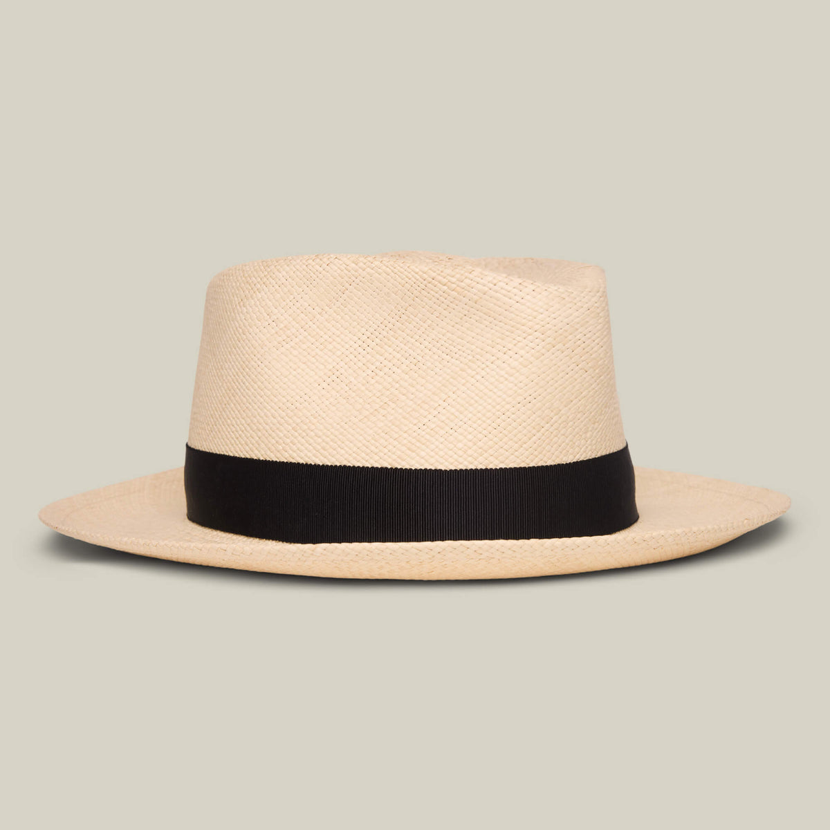 The Goorin Bros. John Sr. is a beige toquilla teardrop fedora with a wide black band and 50 UPF sun protection, shown against a plain light gray background.