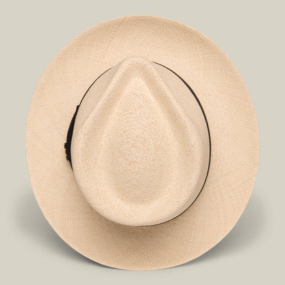The Goorin Bros. John Sr. is a beige toquilla teardrop fedora with a wide brim, dark band, and 50 UPF sun protection, shown from above on a plain background.