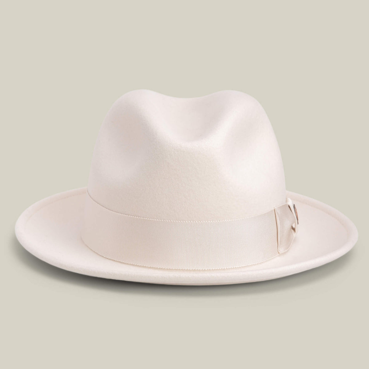 Dean the Butcher by Goorin Bros. is an American-made fedora in DUST, featuring a wide brim and matching grosgrain hatband, shown on a neutral background.